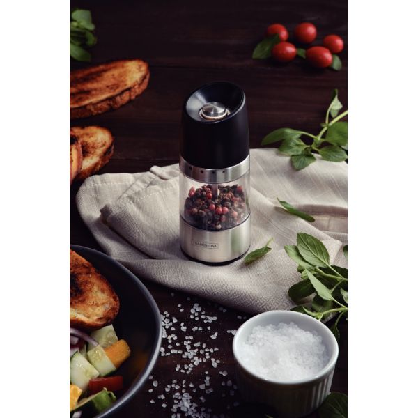 Molino de pimienta y molinillo de sal en una mesa de madera con otros  productos y un cuchillo